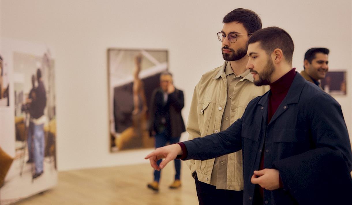 Photo of people looking at the gallery pieces