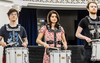 people playing marching drums