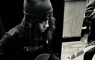 imagine of a guy playing guitar