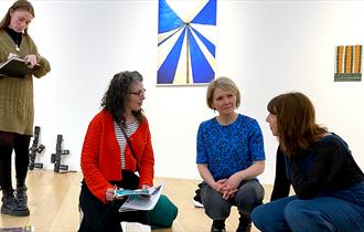 a couple people in an exhibition
