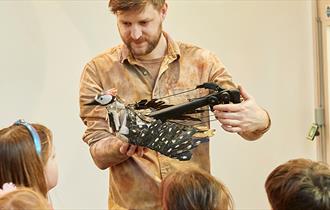 man presenting a workshop to children