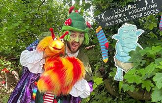 Man dressed up in front of a forest