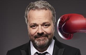Hal Cruttenden being hit with a boxing glove