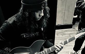 imagine of a guy playing guitar