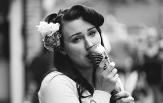 woman singing into a mic
