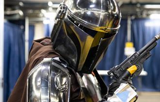 A photo of a cosplayer dressed as Mando from Star Wars