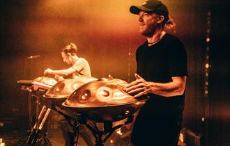 Photo of Hang Massive on stage performing with steel drums