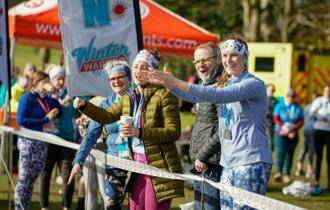 Photo of supporters at the side of the running track