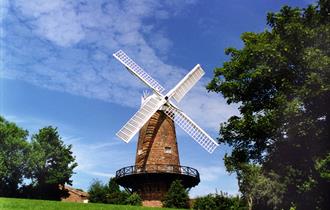 Image is of Green's Windmill with blue summer sky behind