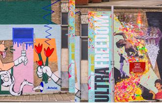 Image of two murals spray painted on to Nottingham buildings