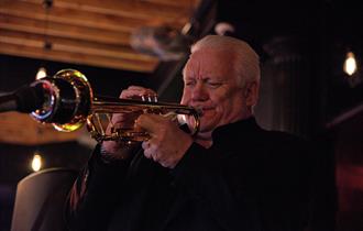 Photo of Bruce Adams performing on stage