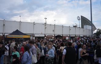 The image shows Trent Bridge Cricket Ground being entered by a large crowd.