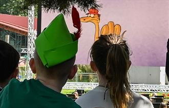 Photo of two young children looking at an outdoor cinema screen