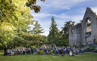 An audience seated in the Palace Gardens at Southwell Minster