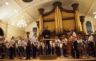 Orchestra performance in front of Binns Organ.