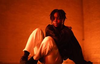 Image of young person sat down on the floor