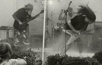 Black and white image of two electric guitarists on stage