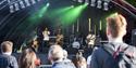 People watching a band on stage at Riverside Festival.