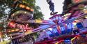 Photo of a fairground ride in action. Slow motion shot.
