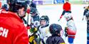 Photo of a coach with young ice hockey students