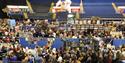 A photo of a crowded arena bowl full of event goers and market stalls