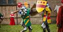 Two armoured knights compete in a medieval battle re-enactment