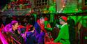 Photo of a family geting greeted by an elf
