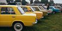 A photo of some classic cars parked in a row for a car show