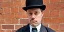 Photo of head interpreter dessed in Edwardian attire