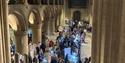 Aerial photograph of crowds gathered around craft stalls in Southwell Minster's central nave