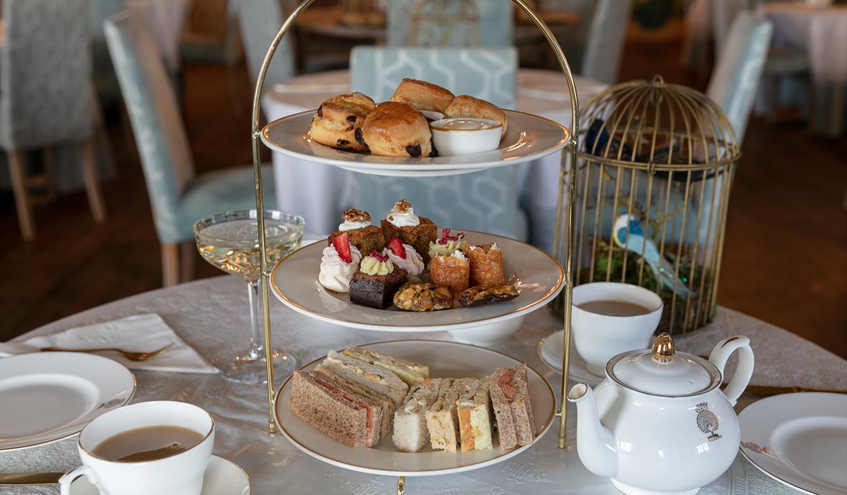A photograph of an Afternoon Tea tower on an ornately dressed tabletop