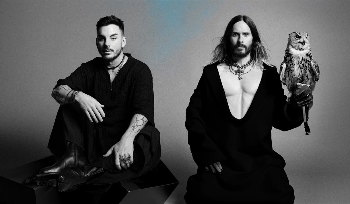 Black and White photo of Thirty Seconds to Mars. Jared Leto is holding an owl.