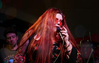 Photo of Alice Armstrong performing on stage