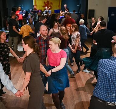 Photograph of people dancing in a group
