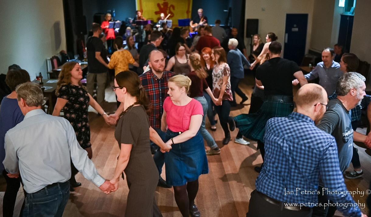 Photograph of people dancing in a group