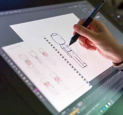 Photo of a person using a stylus on a digital screen, working on an animation piece.
