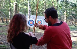 Photo of people learning how to do archery