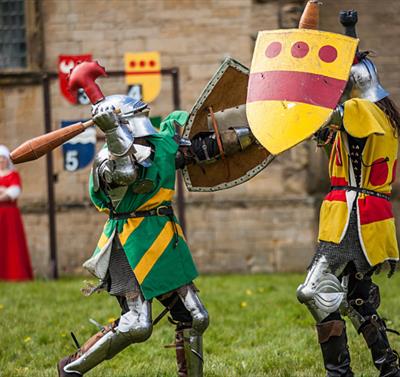 Two armoured knights compete in a medieval battle re-enactment