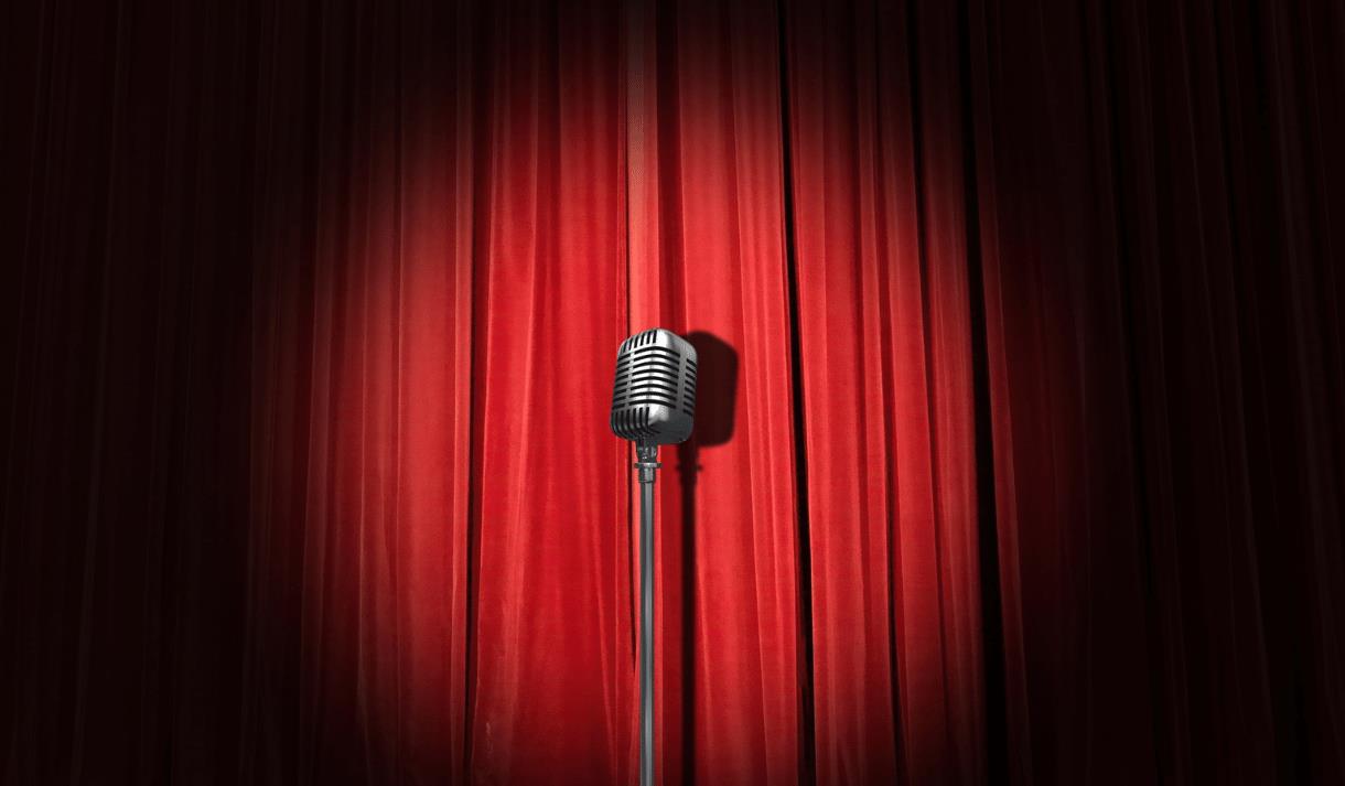 Microphone in front of a red stage curtain
