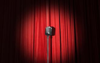 Microphone in front of a red stage curtain