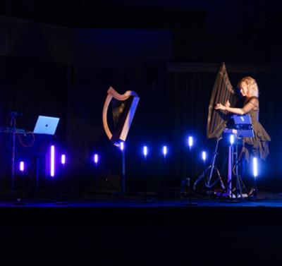 Photograph of harpists on stage.