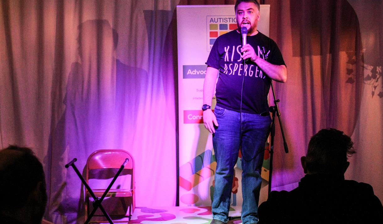 Photo of a comedian on stage.