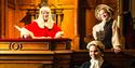 Costumed actors in the courtroom of the National Justice Museum, including a judge, lawyer and defendant