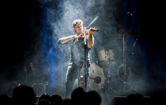 Photo of Seth Lakeman playing a violin on stage