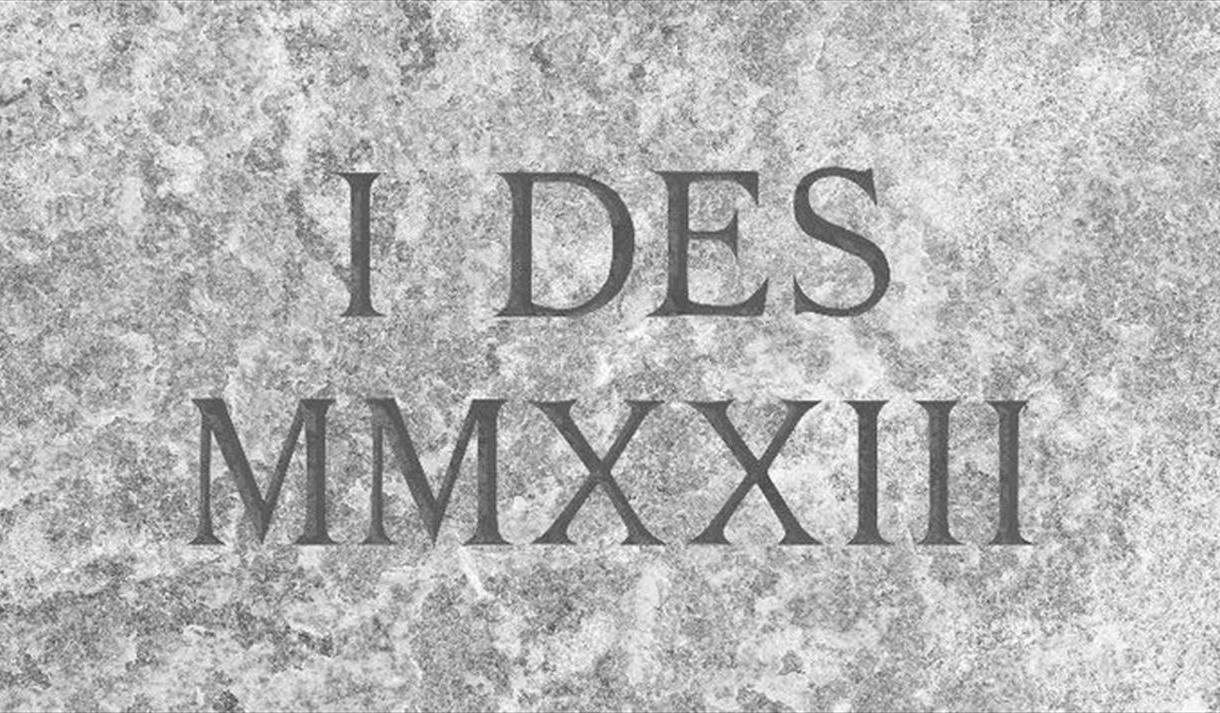 Graphic of I DES MMXXIII as if it were engraved on a marble stone