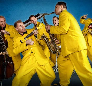 Photo of the jive aces in yellow suits