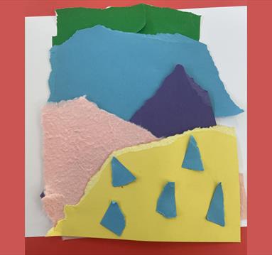Photo of cut up bits of colourful paper arranged in a fun, crafty way.