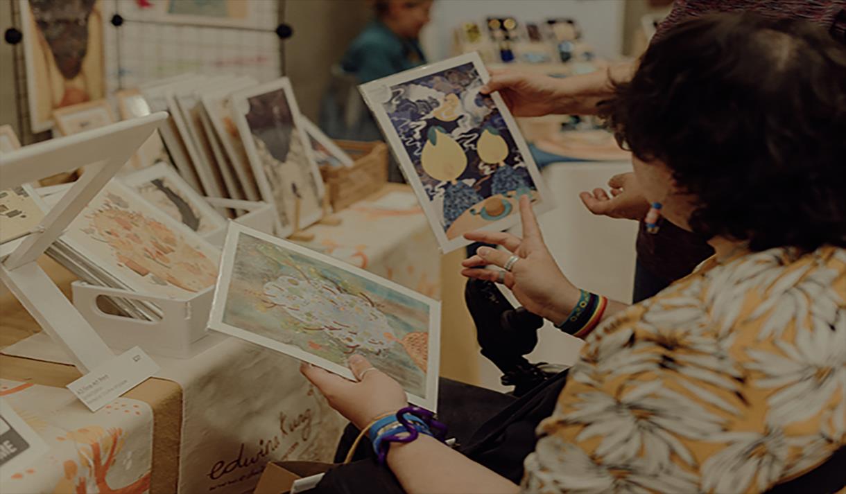Photo of customers browsing art prints at the craft fair