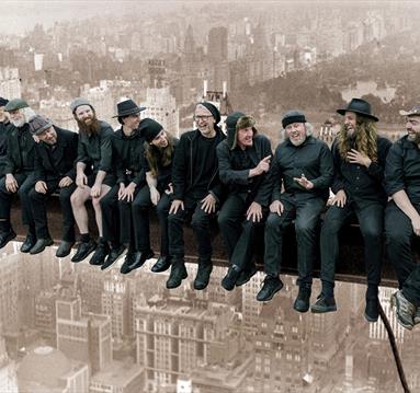 Graphic of The Spooky Men's Chorale showing them recreating the famous image of men sitting along a steel girder in the air when builidng the Empire S
