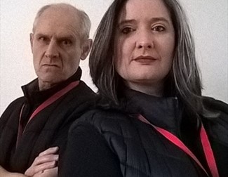 Image of a man and woman dressed in black